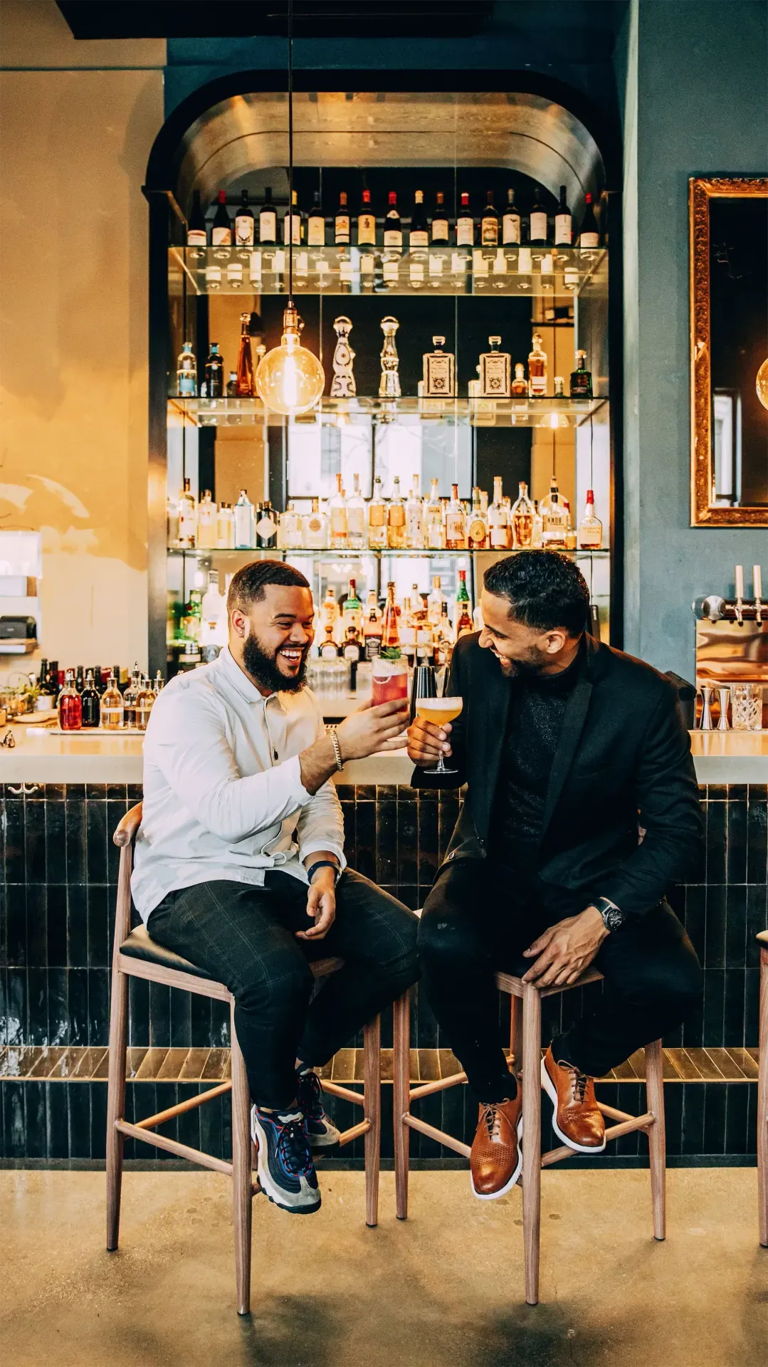 WOA co-founders Fabio Perez and Hector Taveras sharing a laugh and a toast at the bar