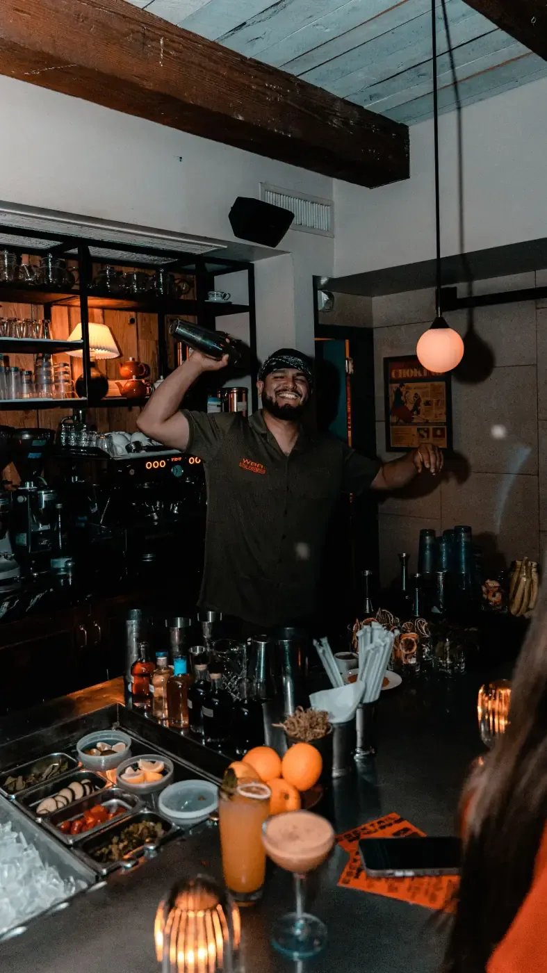 A WOA bartender mid-toss behind the bar